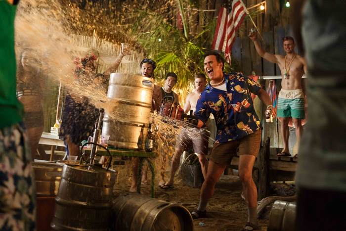 Bruce Campbell spraying beer from a keg at a party
