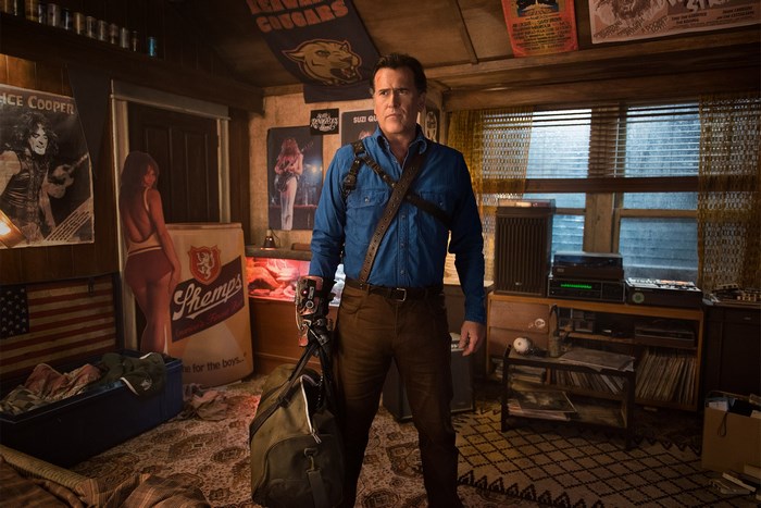 Bruce Campbell in a room with posters