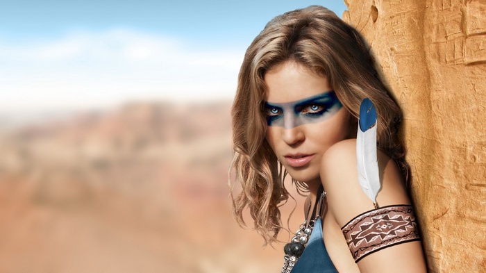 Woman with face paint and feather