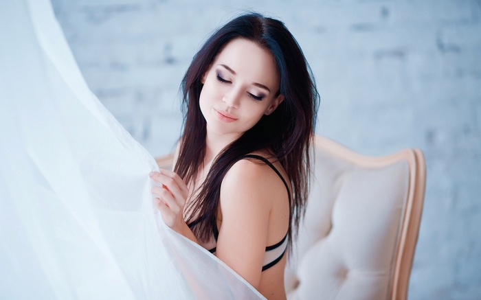 Woman in lingerie sitting on a chair