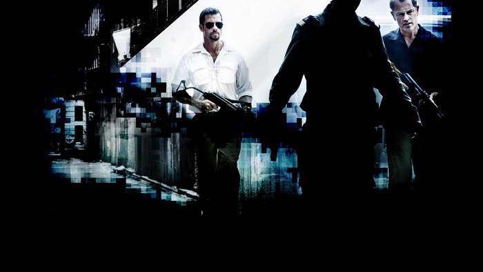 Guy Pearce in a scene with armed men