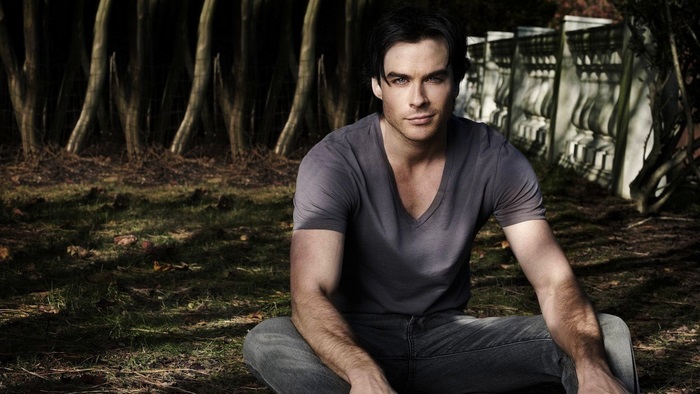 Ian Somerhalder sitting in a forest