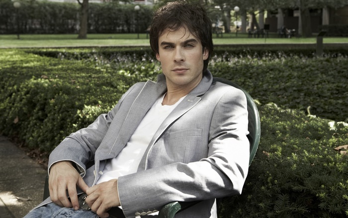 Ian Somerhalder sitting in a park