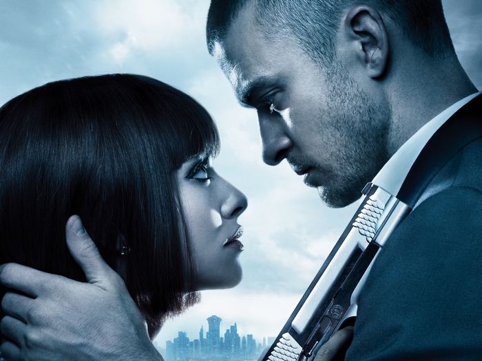 Justin Timberlake in a suit holding a gun