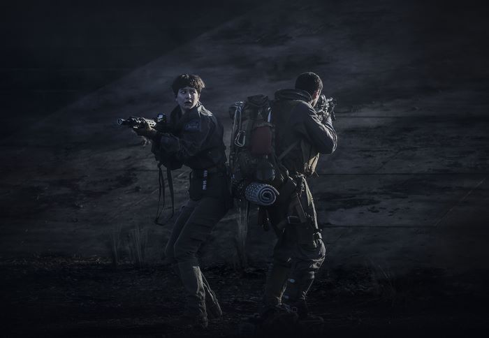 Katherine Waterston with a soldier in tactical gear