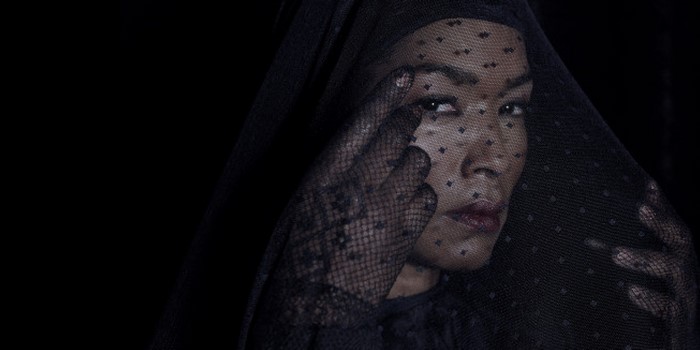 Angela Bassett in black veil