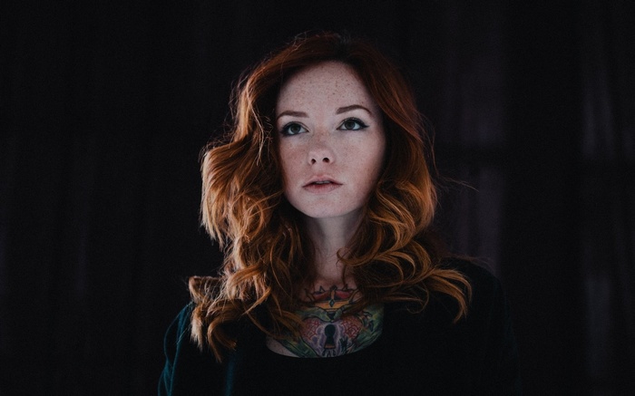 Woman with red hair and tattoos