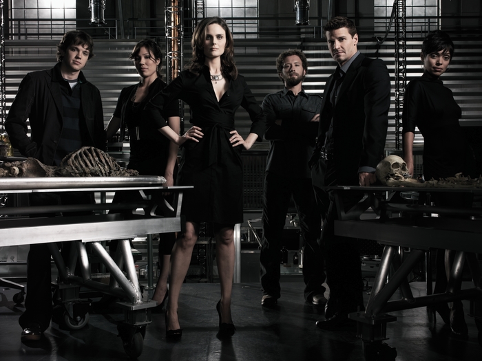Bones cast posing in a lab with skeletons