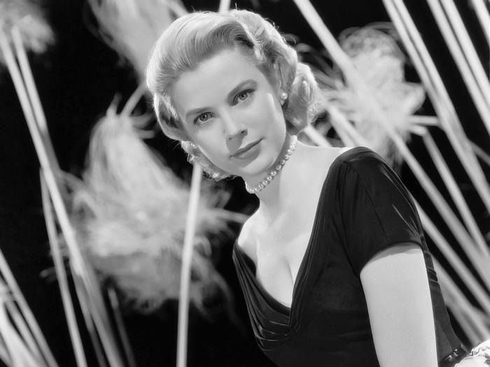Grace Kelly in a black dress with pearls