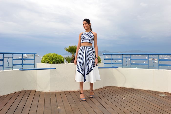Freida Pinto on a balcony overlooking the sea