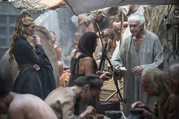 Jonathan Pryce in a scene with other people