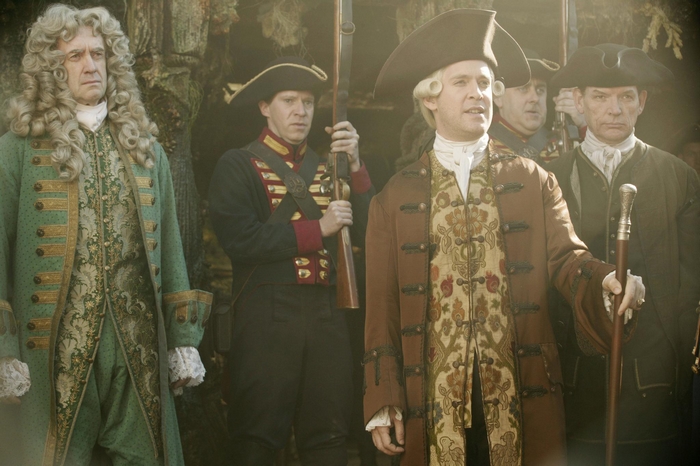 Jonathan Pryce and men in historical costumes