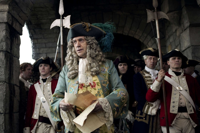Jonathan Pryce in historical costume with guards