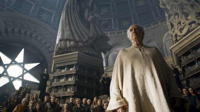Jonathan Pryce in a grand hall