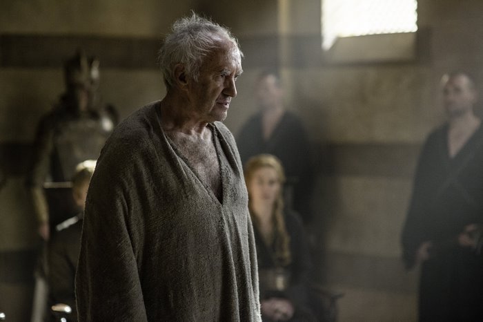Jonathan Pryce in a dimly lit room