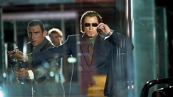 John Travolta and two men in suits