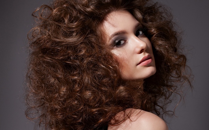 Woman with voluminous curly brown hair