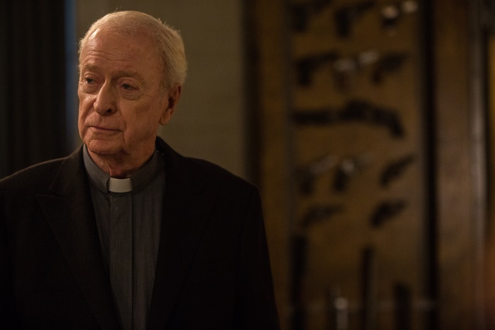 Michael Caine in a priest's collar
