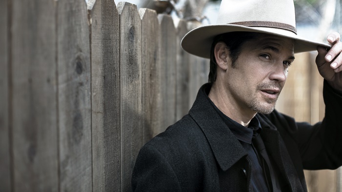 Timothy Olyphant wearing a hat and coat