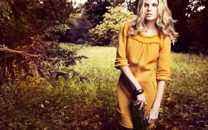 Maryna Linchuk in a yellow dress in a forest