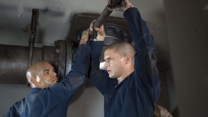 Two men working on pipes