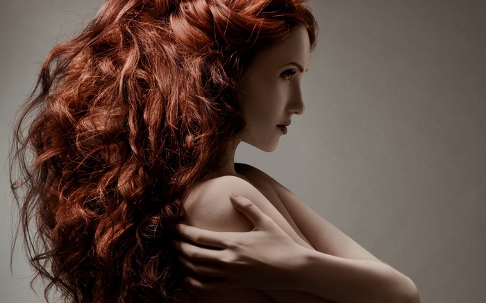 Woman with long red curly hair