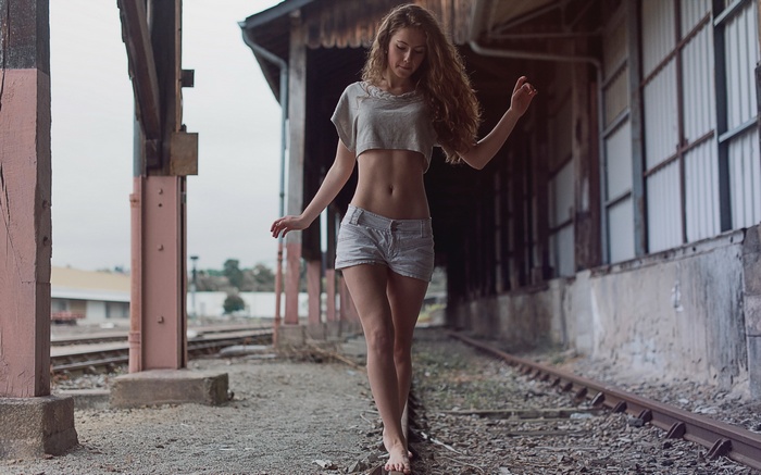 Woman walking on train tracks