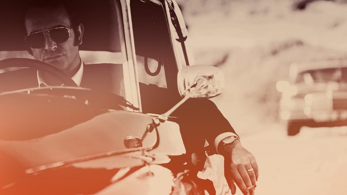 Jean Dujardin driving a car