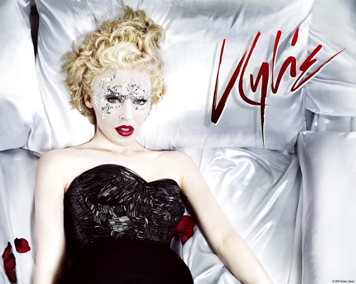 Kylie Minogue lying on pillows
