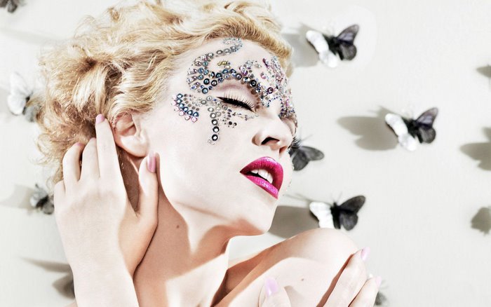 Kylie Minogue with face gems and butterflies