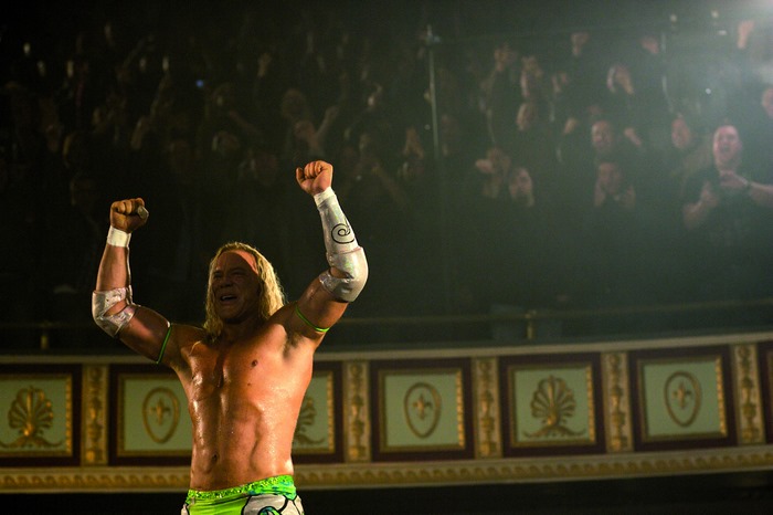 Mickey Rourke celebrating in a wrestling ring