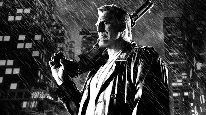 Marv from Sin City holding a gun in the rain