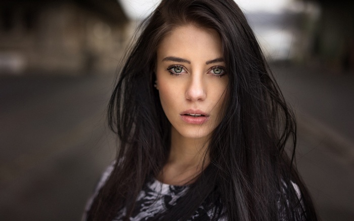 Woman with long dark hair and green eyes