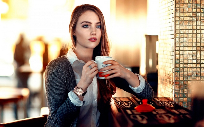 Woman holding a mug in a cafe
