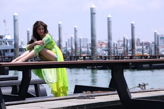 Aditi Rao Hydari sitting on a pier