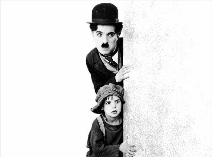 Charlie Chaplin with Child Peeking Behind Wall