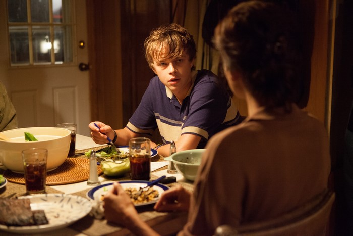 Dane DeHaan at a dinner table