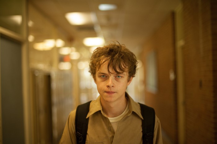 Dane DeHaan in a school hallway