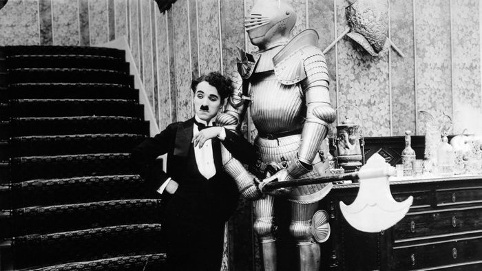 Charlie Chaplin with a suit of armor