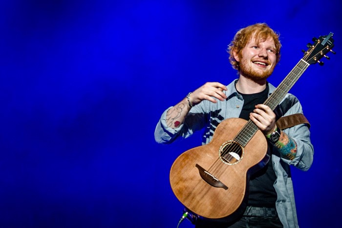 Ed Sheeran performing with guitar