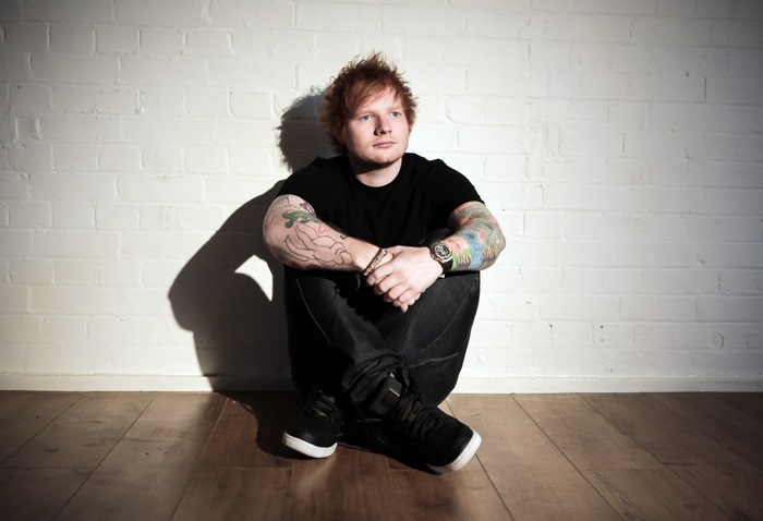 Ed Sheeran sitting on the floor