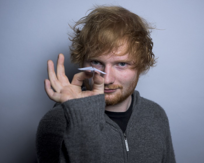 Ed Sheeran holding a paper airplane