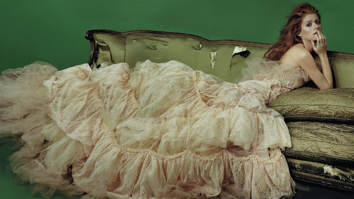 Debra Messing on a green couch