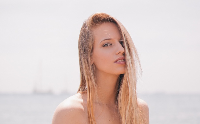 Woman with blonde hair at the beach