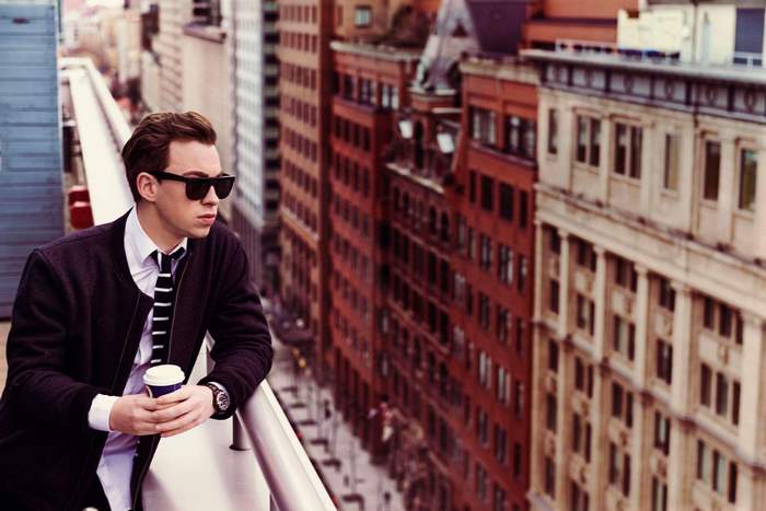Hardwell on a rooftop with city buildings