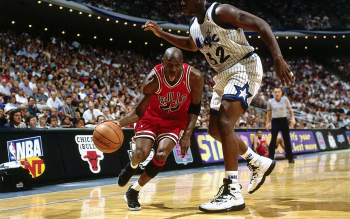 Michael Jordan and Shaquille O'Neal playing basketball