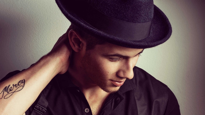 Nick Jonas wearing a fedora