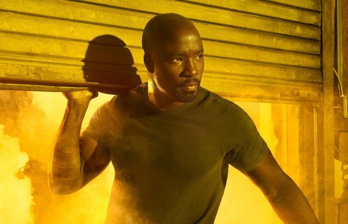 Mike Colter lifting a metal door