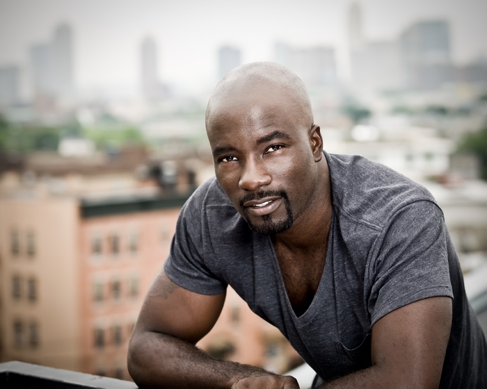 Mike Colter posing on a rooftop