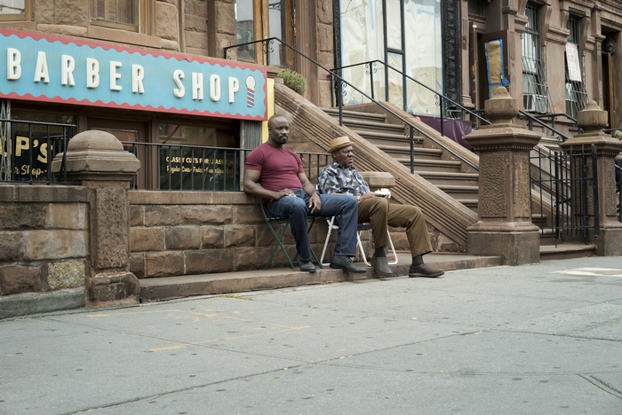 Mike Colter and an older man outside a barber shop
